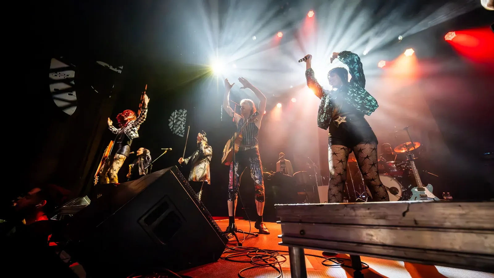 Performers illuminated by bright stage lights